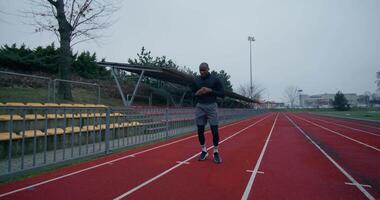 A man is standing on a running track video