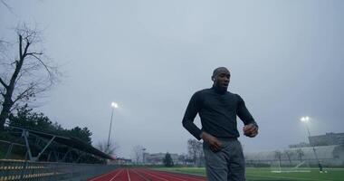 A man running on a track in a foggy day video