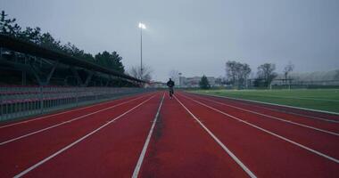 A person is running on a track in a stadium video