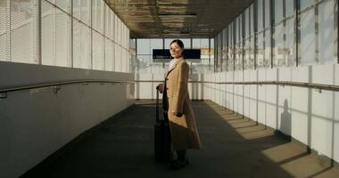 A woman in a coat standing in an empty hallway video