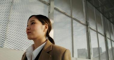 A woman in a business suit standing in front of a window video