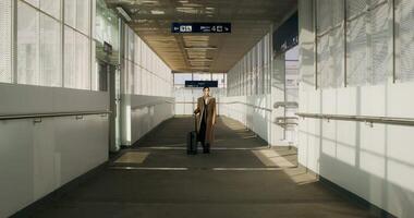 A person walking down a hallway with a suitcase video
