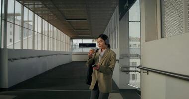 A woman in a coat standing in an empty hallway video