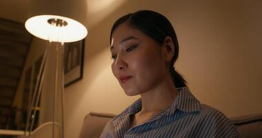 A woman sitting on a couch with a lamp on video