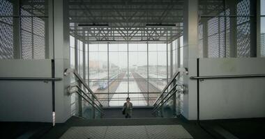 A person walking down an escalator in a building video
