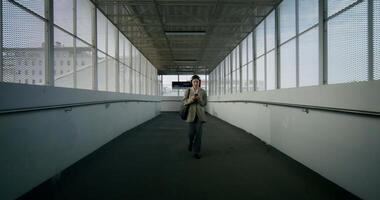A man walking down an empty hallway video