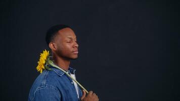 A young man holding a sunflower in his hand video