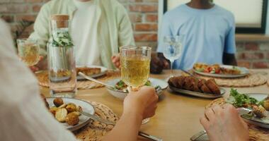 A group of people are toasting at a dinner table video