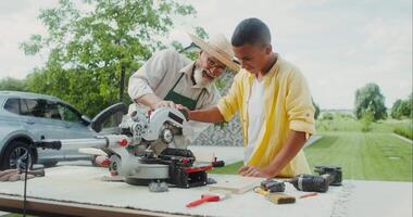 A man and boy working on a table with a circular saw video