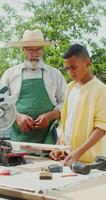 A man and boy working on a table with a saw video