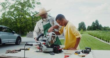 A man and boy working on a table with a circular saw video