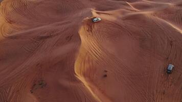 An aerial view of a desert with a car driving on it video