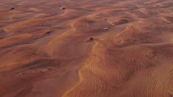 An aerial view of a desert with a car in the middle video