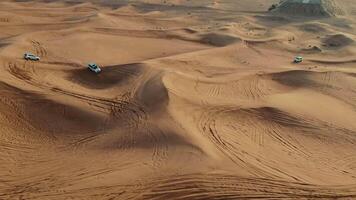 A desert with several vehicles driving on it video