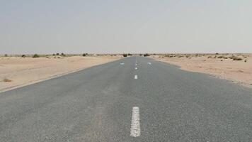 An empty road in the desert with white lines video