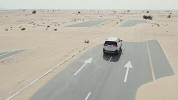 A car driving through the desert with two arrows pointing in different directions video