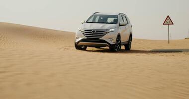 A white suv driving through the desert video