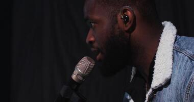 A man with a beard and a microphone video