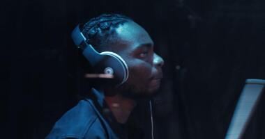 A man wearing headphones in front of a computer video