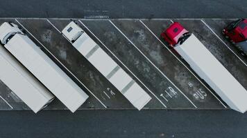 An overhead view of a parking lot with several trucks video