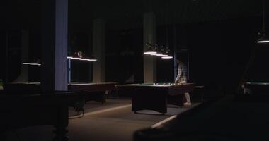 A pool table in a dark room with lights video