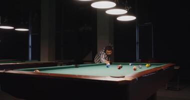 A man is playing pool in a room with lights video