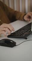A person typing on a keyboard video