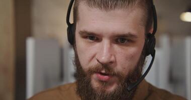 A man with a beard wearing a headset video