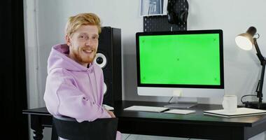 A man in a chair with a green screen in front of him video