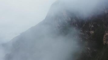 A mountain with fog and clouds above it video