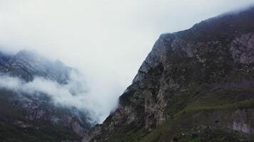 A mountain with a valley and clouds in the background video