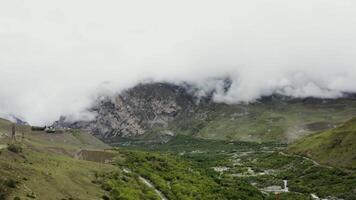 A valley with mountains and clouds in the background video