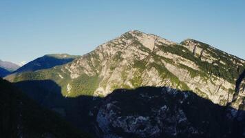 A mountain range with a shadow cast on it video