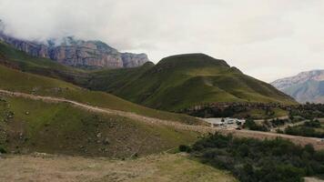 A view of a mountain range with a road in the middle video