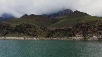 A lake with mountains and clouds in the background video
