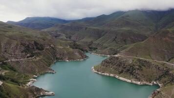 A view of a lake and mountains in the middle of a valley video