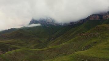 A mountain range with a valley and a cloud covered sky video
