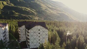 A large building surrounded by trees in the mountains video