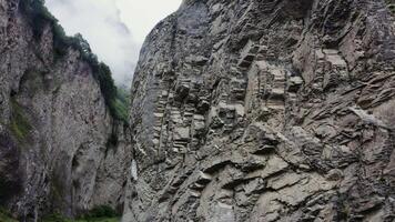 A mountain with a large rock wall on the side video