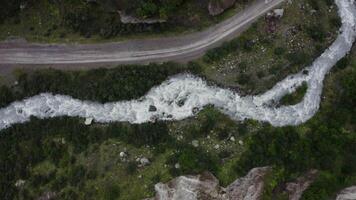 An aerial view of a river flowing through a forest video
