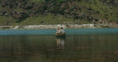 A man and woman in a canoe on a lake video