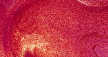 A red and pink background with a white swirl video