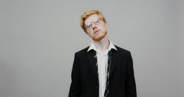 A man with glasses and a suit on video