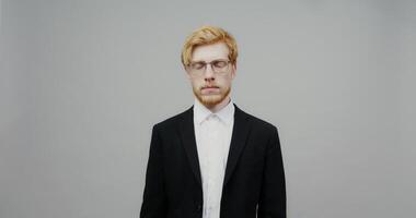 A man in a suit and glasses video