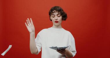 A woman holding a piece of paper and a dollar bill video