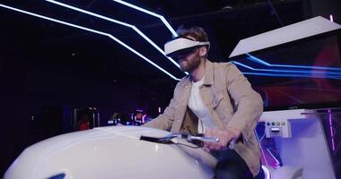 A man wearing a virtual reality headset riding a motorcycle video