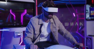 A man wearing a virtual reality headset on a motorcycle video