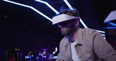 A man wearing a virtual reality headset in a dark room video