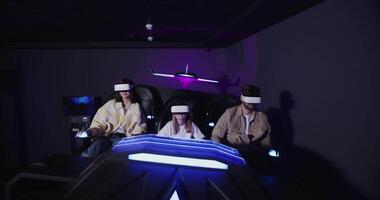 Three people in a room with a game video