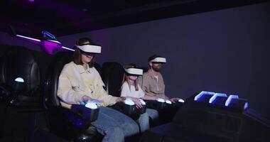 Three people wearing virtual reality headsets in a dark room video
